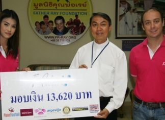 Oussaneeya Puekthong, left, and Jeremy Akoum, right, proprietors of The Perfume House, present a donation of 13,620 baht to Father Peter Srivorakul C.Ss.R., president of the Father Ray Foundation in Pattaya. The donation is the proceeds from an annual soccer competition which is organized by The Perfume House and won this year by the team from the Father Ray Children’s Home.